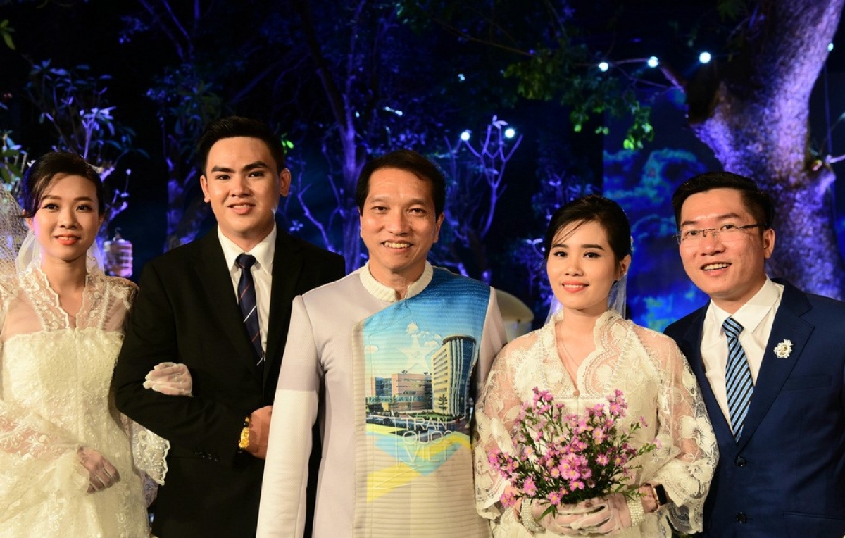 Đại tá Trần Quốc Việt - phó giám đốc Bệnh viện Quân Y 175 chụp hình cùng các cặp đôi. Ảnh: Tuổi trẻ online
 