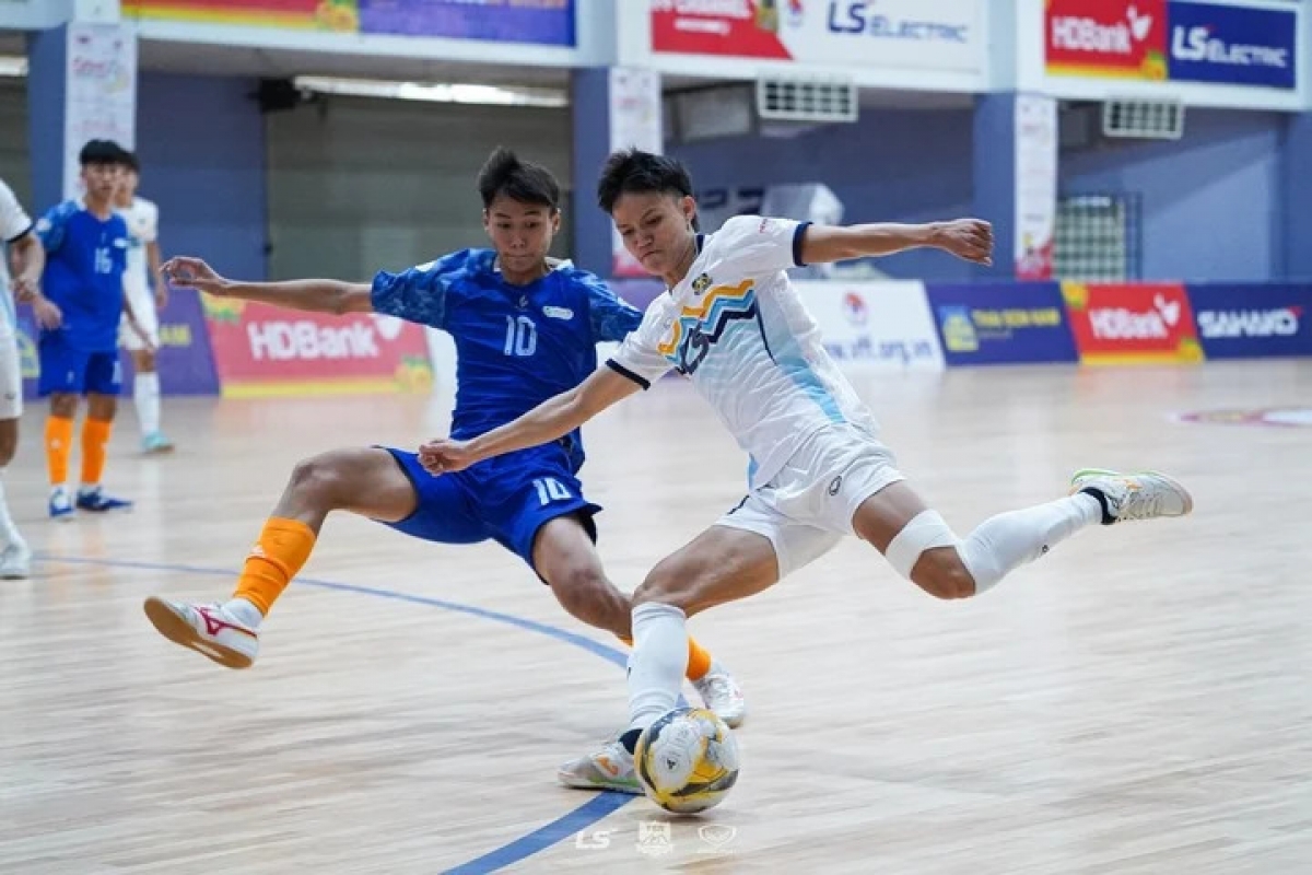 Dương Ngọc Linh (áo trắng) nỗ lực dứt điểm trong sự đeo kèm quyết liệt của cầu thủ Trẻ TPHCM. ẢNH: ANH TRẦN.