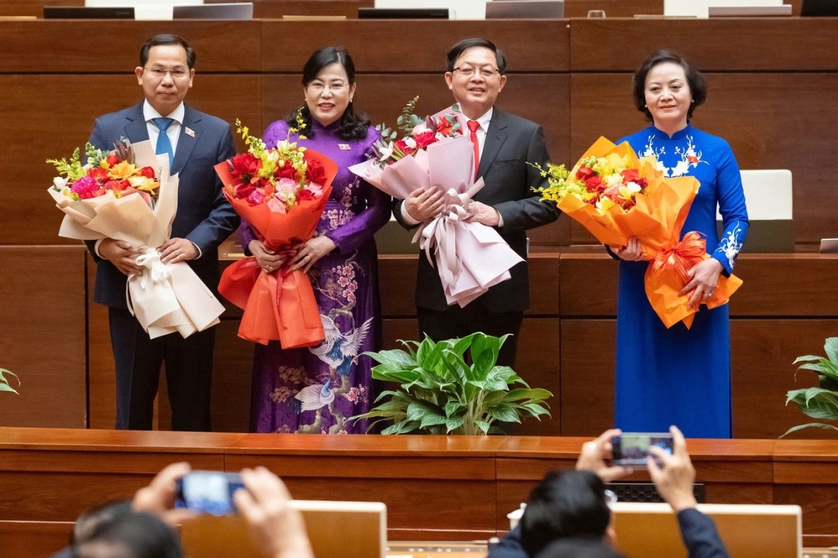 Hai tân Phó Thủ tướng và các nhân sự mới được Quốc hội bầu nhận hoa chúc mừng của lãnh đạo Đảng, Nhà nước. Ảnh - Nguồn: Dantri.com.vn