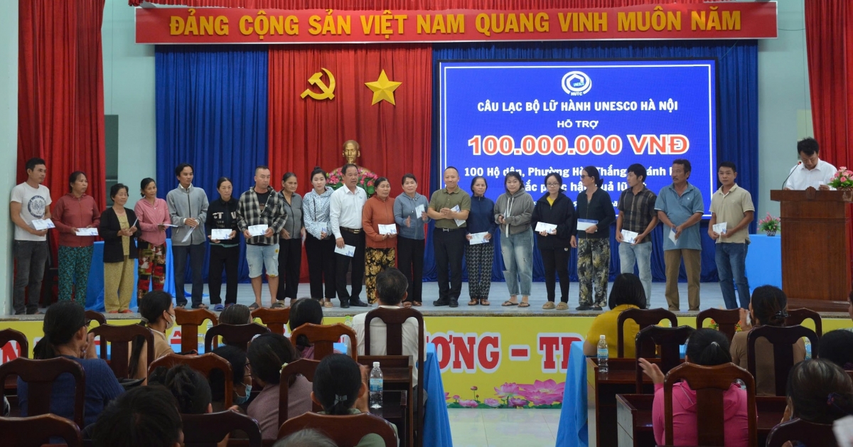Đại diện Câu lạc bộ Lữ hành UNESCO Hà Nội trao quà cho người dân phường Hòa Thắng. Ảnh: HUTC