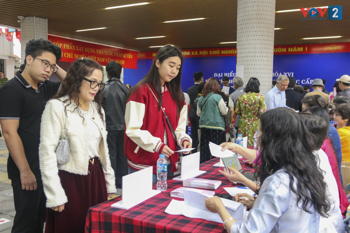 Tại bàn hướng dẫn, thành viên Tổ bầu cử cẩn thận kiểm tra Thẻ cử tri và đối chiếu với danh sách đã được niêm yết để xác nhận tư cách hợp lệ trước khi phát phiếu bầu.